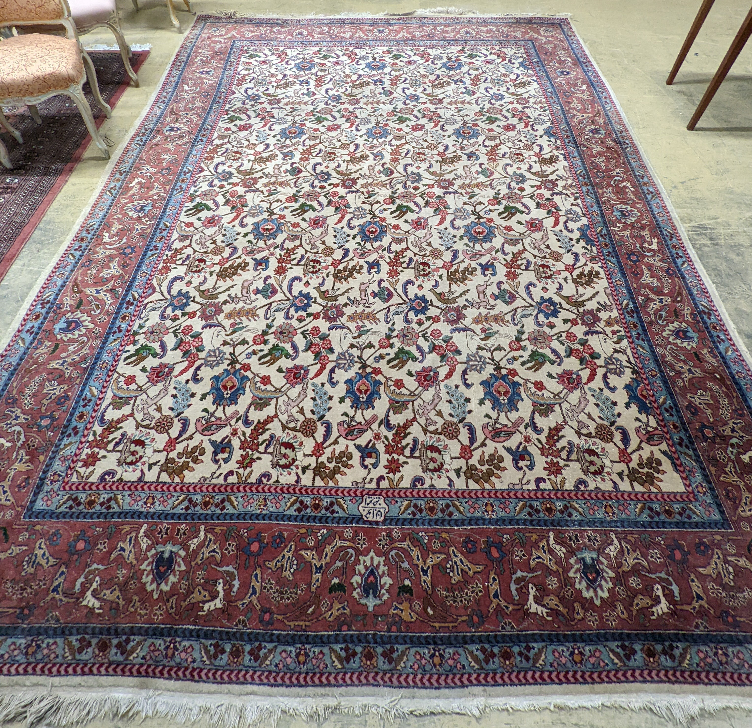 An Ispahan ivory ground carpet woven with flowers and animals, 386 x 276cm